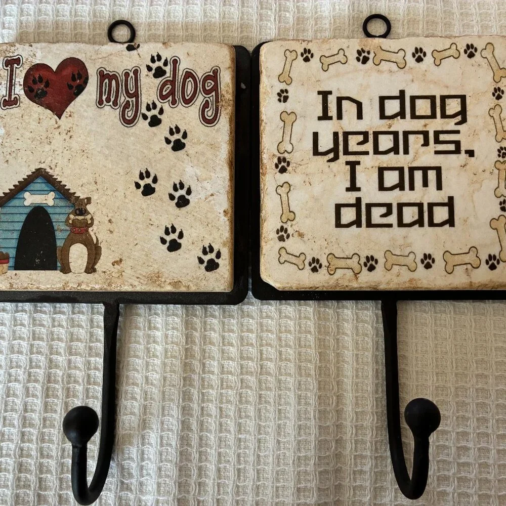 Two Italian marble dog-themed wall hooks
